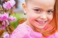 Cute happy joyful girl with long hair close up. Springtime. Childhood. Funny holliday. Cute child having fun on a sunny Royalty Free Stock Photo