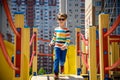 Cute happy kid, boy playing in inflatable attraction on playground