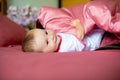 Cute happy laughing baby playing on bed. Royalty Free Stock Photo