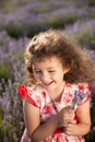 Beautiful happy laughing little girl with bouquet of flowers in lavender field Royalty Free Stock Photo