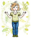 Cute happy little blonde girl posing on background of spring landscape and wearing fashionable casual clothes.