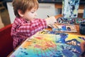 Cute happy little boy, adorable preschooler, painting in a sunny art studio. Young artist at work Royalty Free Stock Photo