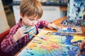 Cute happy little boy, adorable preschooler, painting in a sunny art studio. Young artist at work Royalty Free Stock Photo