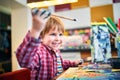 Cute happy little boy, adorable preschooler, painting in a sunny art studio. Young artist at work Royalty Free Stock Photo