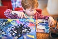 Cute happy little boy, adorable preschooler, painting in a sunny art studio. Young artist at work Royalty Free Stock Photo