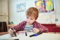 Cute happy little boy, adorable preschooler, painting in a sunny art studio. Young artist at work Royalty Free Stock Photo