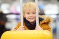 Cute happy little boy with big yellow suitcase at international airport before flight Royalty Free Stock Photo