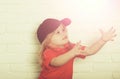 Cute happy little boy in blue cap and red shirt Royalty Free Stock Photo