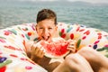 Happy little boy having fun in rubber ring eating juicy watermelon Royalty Free Stock Photo