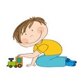 Cute happy little boy is kneeling on the floor, playing with train