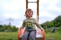 Cute happy little boy playing on slide in Playground Royalty Free Stock Photo