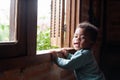 Cute and happy little boy smiling to the camera  inside the house near the window Royalty Free Stock Photo