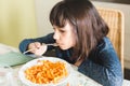 Little girl eating pasta with tomatoo sauce Royalty Free Stock Photo