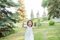 Cute happy little girl in a hat having fun in park meadow. Picnic on nature Royalty Free Stock Photo
