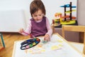 Cute happy little girl painting with water color Royalty Free Stock Photo