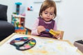 Happy little girl, preschooler, painting with water color Royalty Free Stock Photo