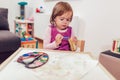 Happy little girl, preschooler, painting with water color Royalty Free Stock Photo