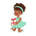 Cute happy little girl wearing magic mint dress sitting with gift box. Kids birthday party colorful cartoon character Royalty Free Stock Photo