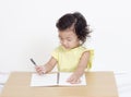 Cute happy little girl writing something Royalty Free Stock Photo