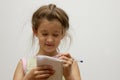 Cute happy little girl writing something in her notebook Royalty Free Stock Photo