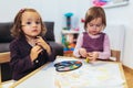 Cute happy little girls, preschooler, painting with water color Royalty Free Stock Photo