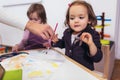 Happy little girls, preschooler, painting with water color, selective focus Royalty Free Stock Photo