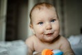 Cute happy 6 month baby boy in diaper lying and playing Royalty Free Stock Photo