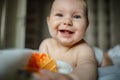 Cute happy 6 month baby boy in diaper lying and playing Royalty Free Stock Photo