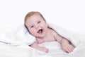Cute happy 3 month baby boy or girl lying on a white towel. Concept for articles about childhood or advertising for babies Royalty Free Stock Photo