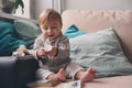 Cute happy 11 month baby boy playing at home, lifestyle capture in cozy interior