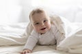 Cute happy 7 month baby girl in diaper lying and playing Royalty Free Stock Photo