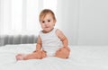 cute happy 8 month old baby girl in diaper lying and playing Royalty Free Stock Photo