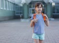 Cute happy schoolgirl with backpack leaving school