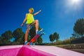 Preteen skater boy with green hair stand on skateboard Royalty Free Stock Photo