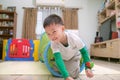 Cute happy smiling Asian little boy playing and having fun inside toy tunnel tube indoor at home Royalty Free Stock Photo