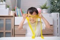 Asian Kindergarten school boy having fun making yellow fluffy slime, Young kid having fun playing and being creative by science