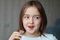 Cute happy smiling little girl eating chocolate with funny face expression Royalty Free Stock Photo