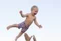 Cute happy smiling toddler having fun on the sea. Father throwes up his little son Royalty Free Stock Photo