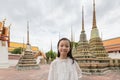 Cute happy smiling tourist girl at Wat Phra Chetuphon or Wat Pho is a Buddhist temple in the city of Bangkok,Thailand, summer vac Royalty Free Stock Photo