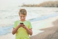 Cute happy smiling white kid using modern smart phone Royalty Free Stock Photo