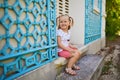 Cute happy toddler girl sitting on the stairs Royalty Free Stock Photo