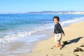 Happy boy running to sea and playing on beach on Mallorca Royalty Free Stock Photo