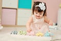 Cute happy 1 year old baby girl playing with wooden toys at home Royalty Free Stock Photo