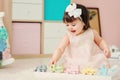 Cute happy 1 year old baby girl playing with wooden toys at home. Royalty Free Stock Photo