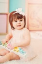 Cute happy 1 year old baby girl playing with wooden toys at home Royalty Free Stock Photo