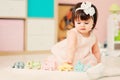 Cute happy 1 year old baby girl playing with wooden toys at home Royalty Free Stock Photo