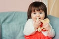 Cute happy 1 year old baby girl playing with wooden toys at home Royalty Free Stock Photo