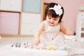 Cute happy 1 year old baby girl playing with wooden toys at home Royalty Free Stock Photo