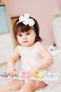 Cute happy 1 year old baby girl playing with wooden toys at home Royalty Free Stock Photo