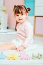 Cute happy 2 years old baby girl playing with toys at home Royalty Free Stock Photo